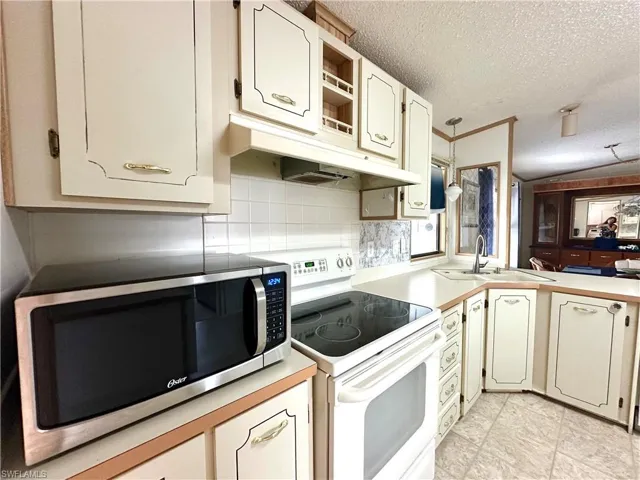 Kitchen, showing the additional transom window and opening leading to the breakfast bar.