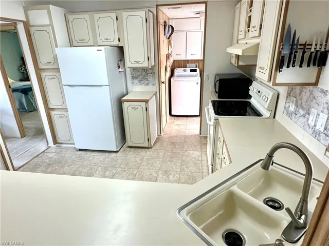 Kitchen and entry way to the laundry room and master bedroom.