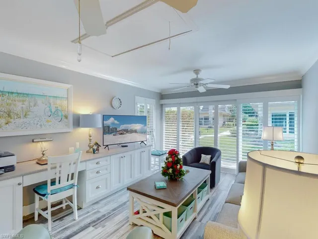Sunroom / solarium featuring ceiling fan