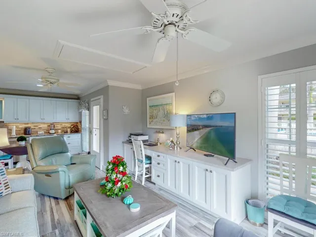Living room featuring light hardwood / wood-style floors and ornamental molding