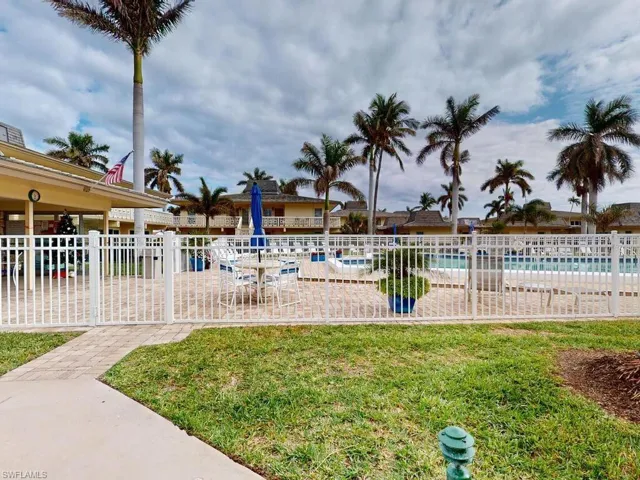 View of pool featuring a lawn and a patio