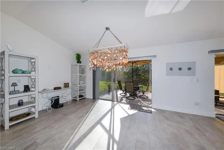 Dining room featuring a chandelier, hardwood / wood-style floors, and vaulted ceiling