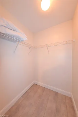 Walk in closet featuring wood-type flooring