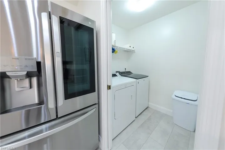 Washroom featuring independent washer and dryer