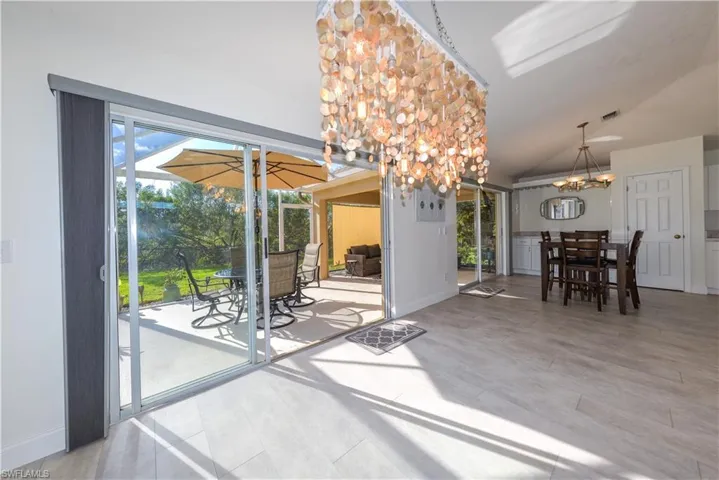 Unfurnished dining area featuring lofted ceiling and a chandelier