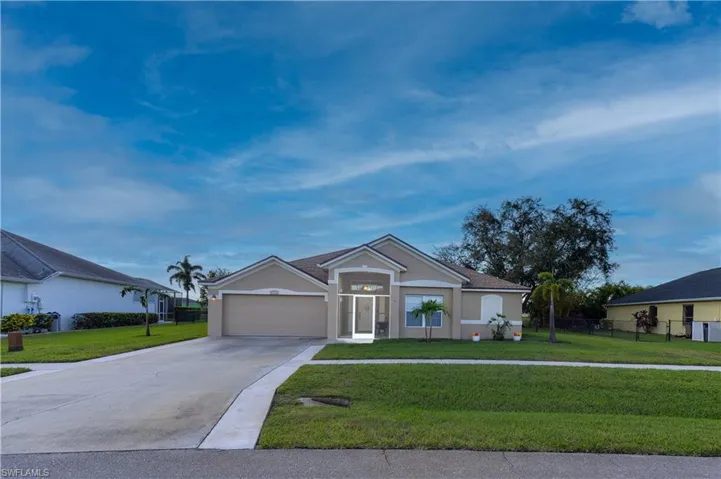 Single story home with a garage and a front yard