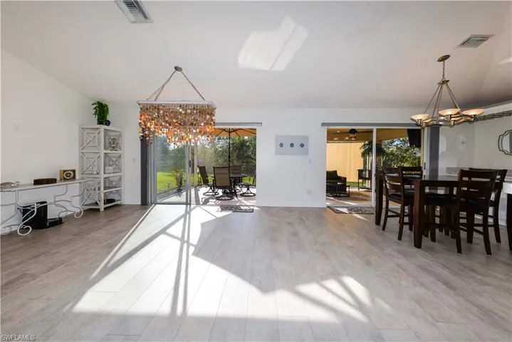 Dining area featuring a notable chandelier and hardwood / wood-style flooring