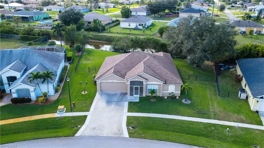 Birds eye view of property with a water view