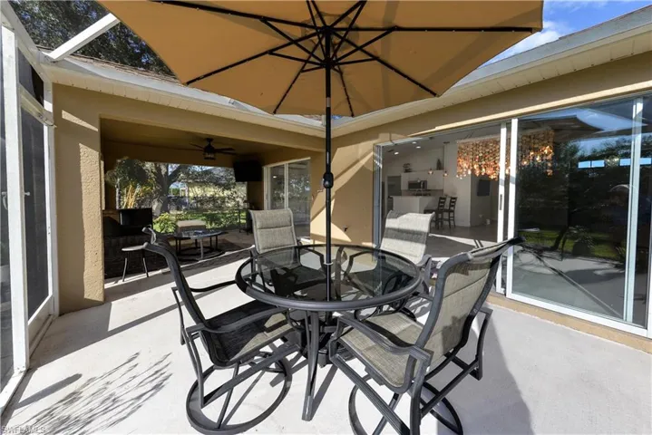 Sunroom / solarium featuring ceiling fan and vaulted ceiling