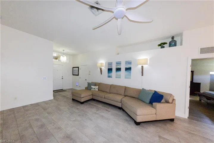 Living room featuring ceiling fan and light wood-type flooring