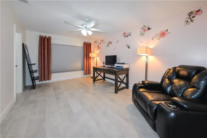 Office with light hardwood / wood-style floors and ceiling fan