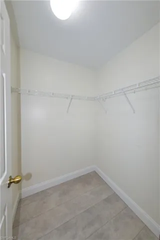 Spacious closet with light tile patterned floors
