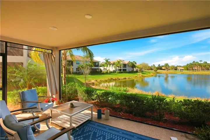 Sunroom featuring a water view
