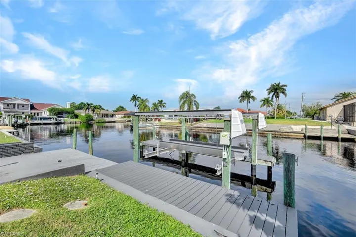 Dock with boat lift and a water view