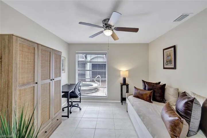 Office with light tile patterned floors and a ceiling fan