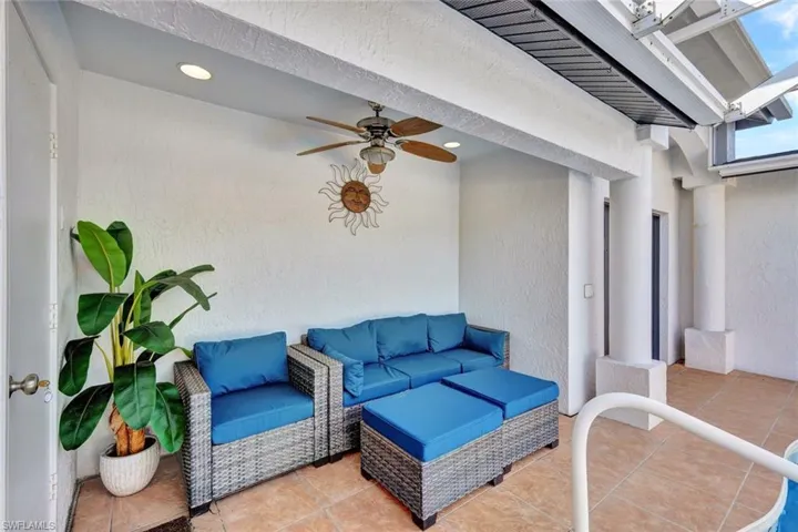 View of patio featuring ceiling fan and an outdoor living space