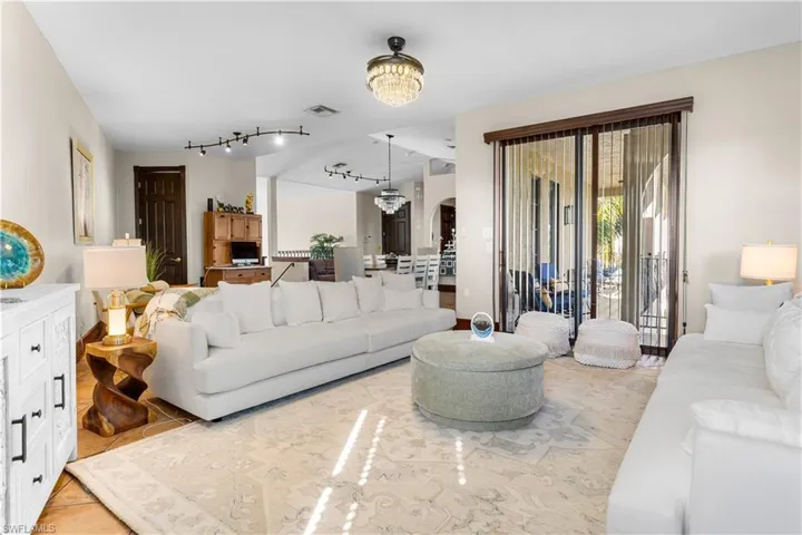 Living area with a chandelier and arched walkways