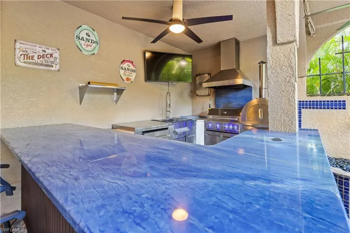 View of patio featuring ceiling fan and a grill
