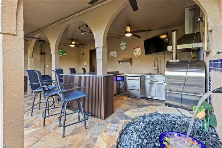 View of patio / terrace with a ceiling fan and exterior kitchen