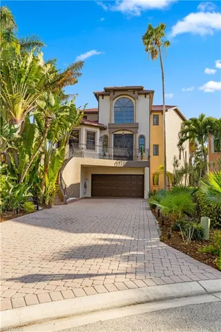 Mediterranean / spanish home featuring a balcony, decorative driveway, stucco siding, a tile roof, and a garage