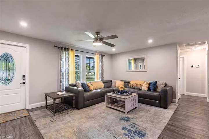 Living area featuring ceiling fan, wood finished floors, and recessed lighting