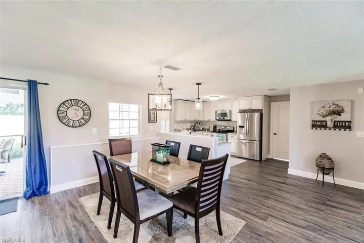 Dining room with dark wood-style flooring