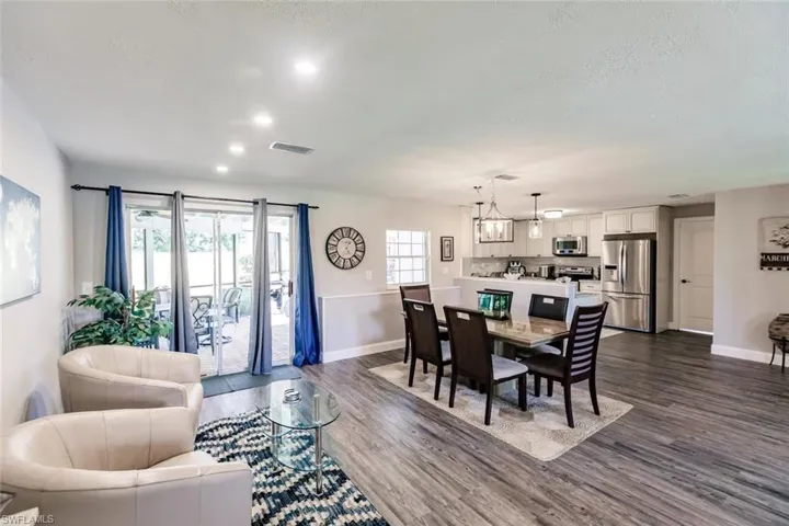 Dining space featuring dark wood-style floors and baseboards