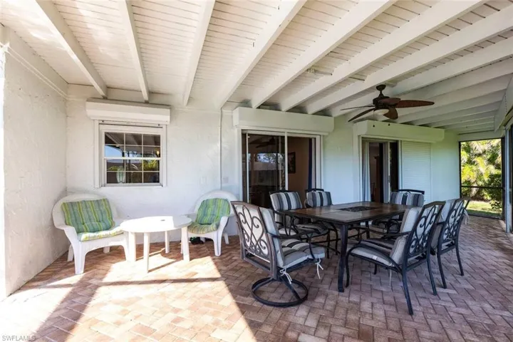 View of patio featuring a ceiling fan and outdoor dining area