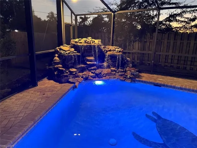 View of pool with a lanai and a sunroom