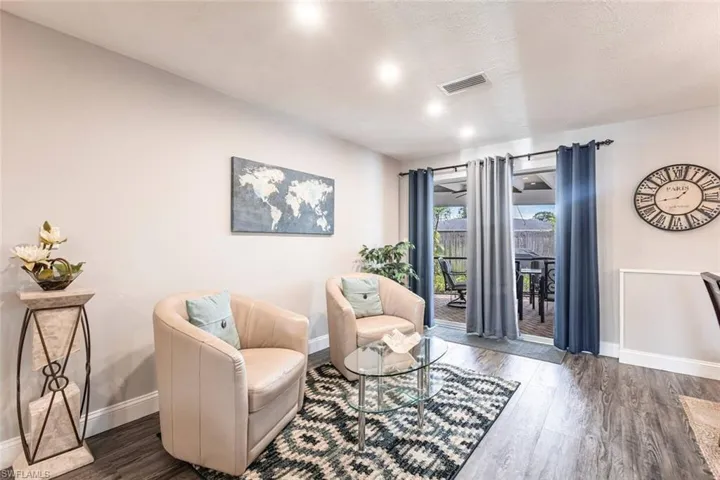 Sitting room with dark wood finished floors and baseboards