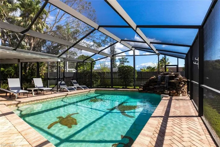 View of yard with a sunroom and a ceiling fan