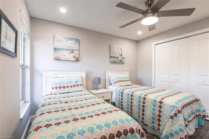 Bedroom featuring ceiling fan, recessed lighting, a closet, and wood finished floors