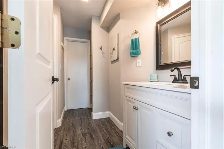Bathroom featuring vanity and dark wood-style flooring