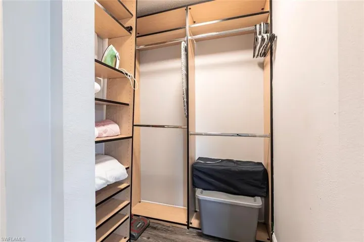 Walk in closet with wood finished floors
