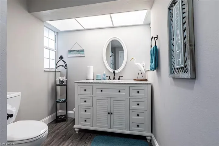 Bathroom with vanity and dark wood-style floors