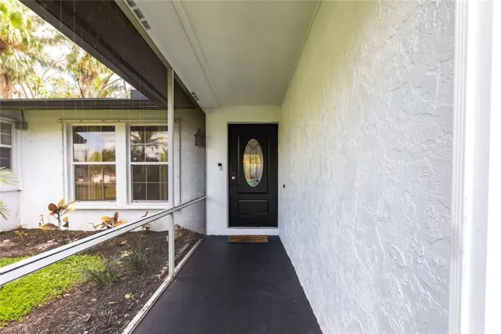 View of exterior entry featuring stucco siding