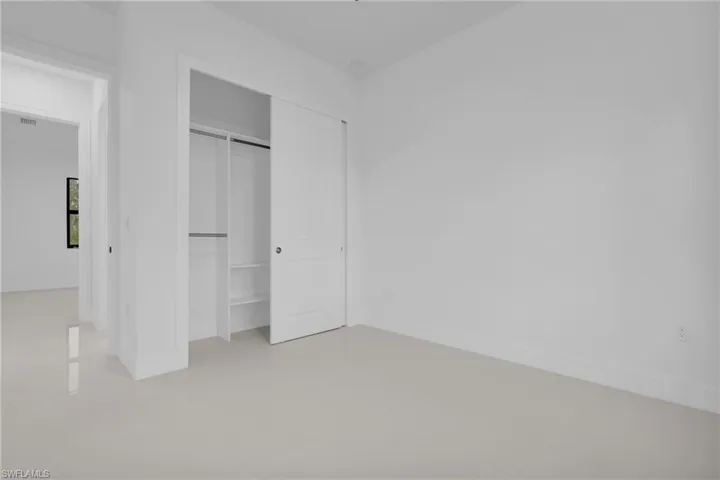 Unfurnished bedroom featuring a closet and light tile patterned flooring