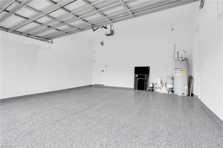 Garage with electric water heater and a garage door opener