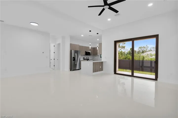 Unfurnished living room featuring recessed lighting, light tile patterned floors, and a ceiling fan