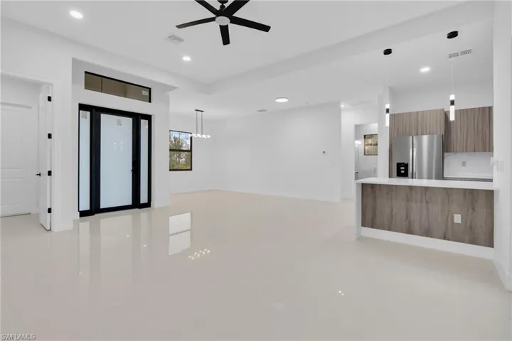 Unfurnished living room featuring ceiling fan, recessed lighting, and light tile patterned floors