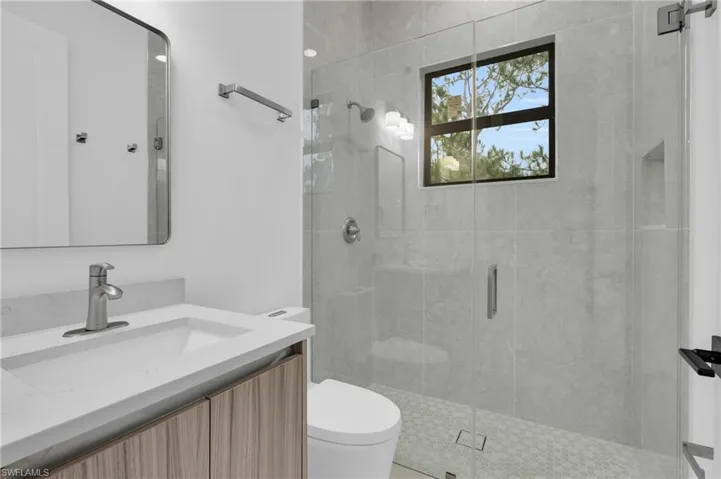 Full bathroom with a shower stall and vanity
