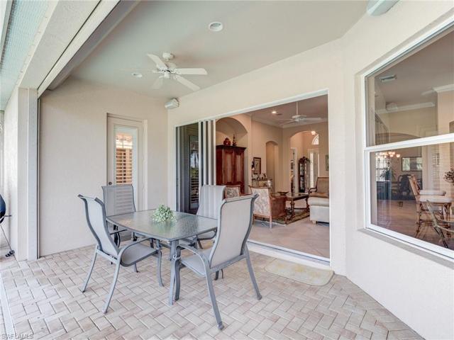Covered lanaI off the open living area.  Pool bath door to left of sliders.