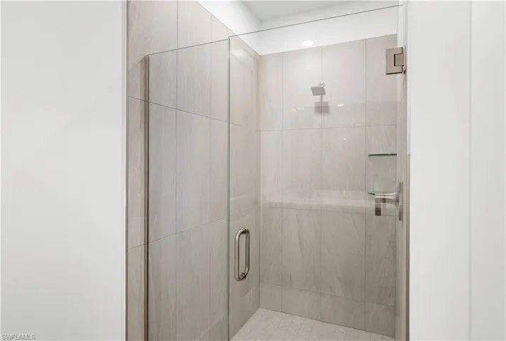 Luxe, walk-in shower with gorgeous shower floor and wall tile