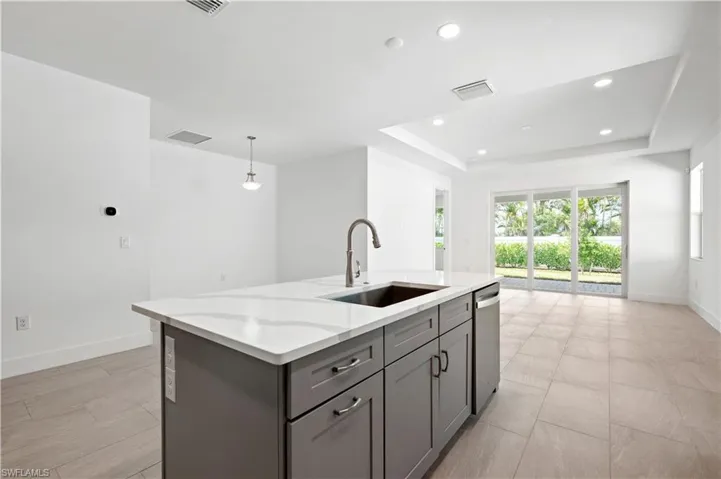 Kitchen island with stainless steel farmhouse sink and pull-down faucet