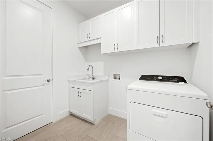 Laundry room with washer and gas dryer