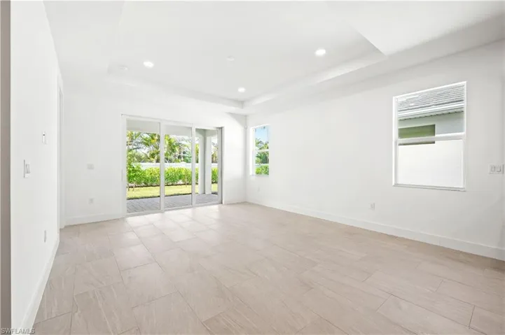 Great room living area with tray ceiling