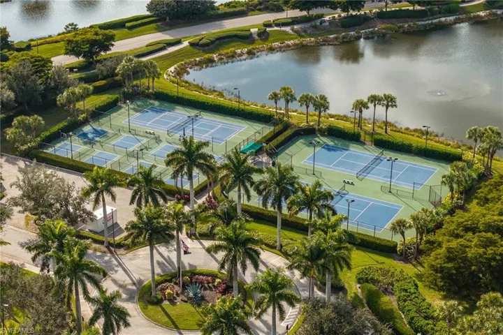 Multiple tennis courts and pickleball courts with perimeter fencing