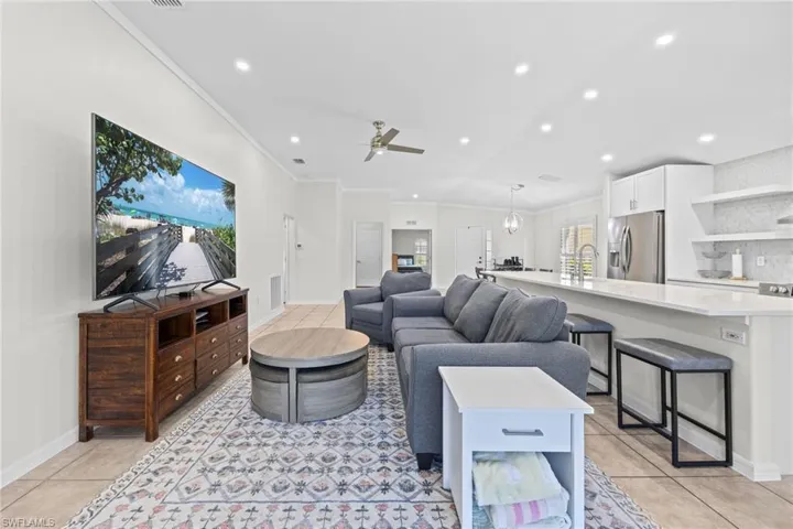 Open-concept living area featuring recessed lighting, tile flooring, and a ceiling fan