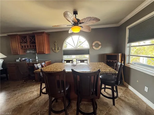 Dining area with crown molding and ceiling fan