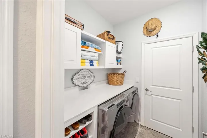 Laundry area featuring washer and dryer and cabinet space